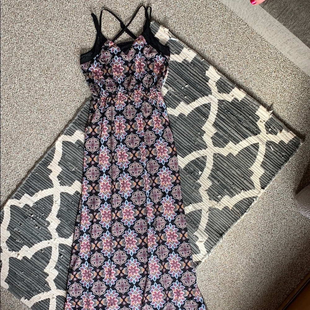 Black maxi dress with floral accents.